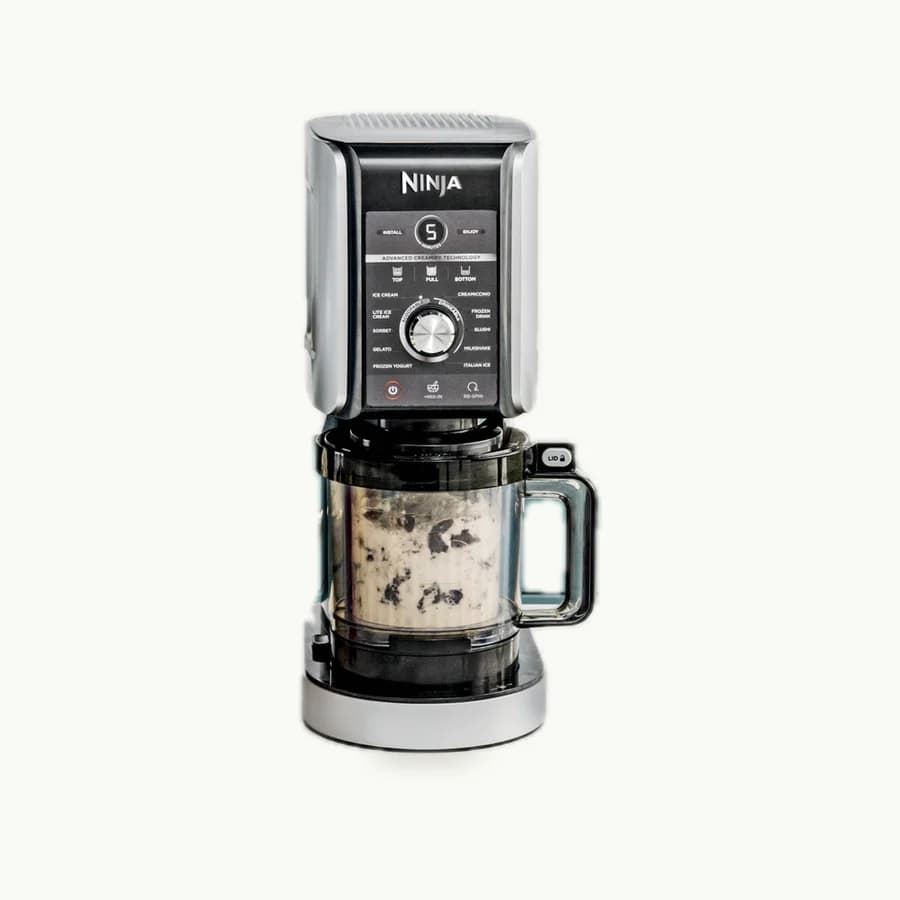 CREAMi Deluxe Ice Cream Maker: Ninja CREAMi Deluxe machine with a pint container in place