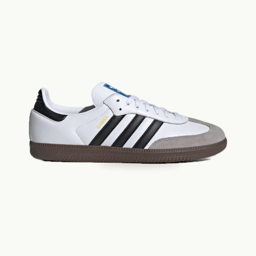 Samba OG: One white Samba OG sneaker with black stripes, gray suede toe trim and a gum sole, viewed from the side