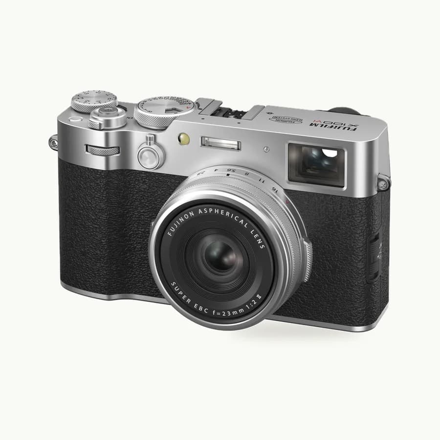 X100VI Compact Camera: Silver and black Fujifilm X100VI camera with its fixed lens shown at a three-quarter angle