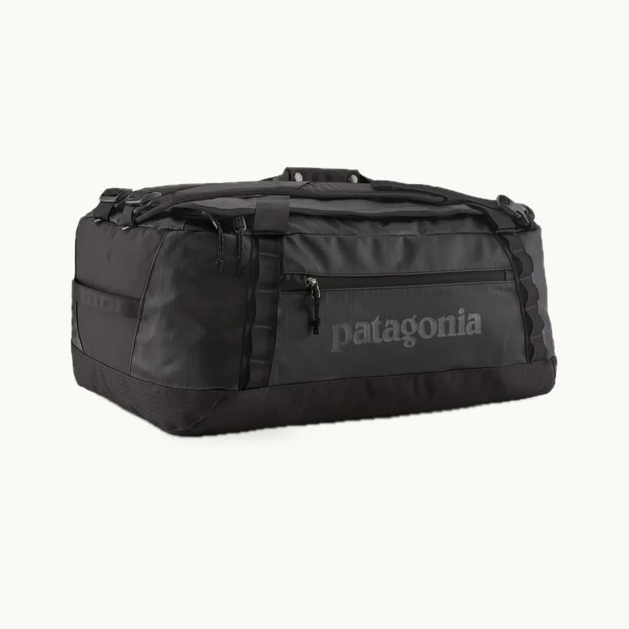 Black Hole Duffel (55L): Black Patagonia Black Hole 55-liter duffel shown whole at a three-quarter angle with its straps folded on top